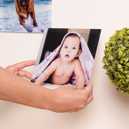 Glass photo tiles with an image of an adorable baby printed inside.