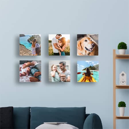 Six glass photo prints on a living room wall.