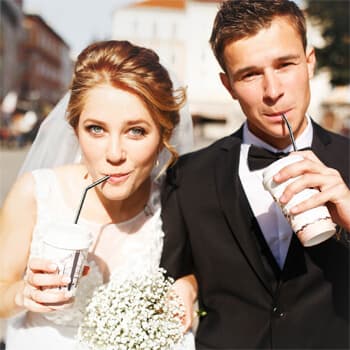 A wedding couple drinks coffee